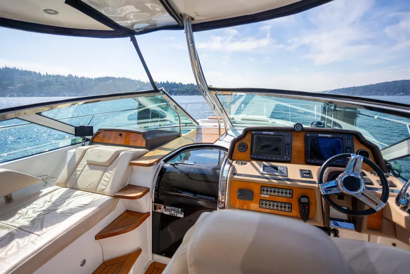 Yacht Photos Pics 2018 Cobalt 46 Yacht cockpit with luxurious seating and advanced navigation controls on open water.