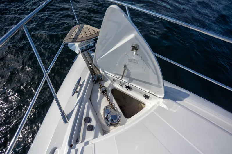  Yacht Photos Pics Bow of 2018 Cobalt 46 Yacht with anchor compartment open, on calm water.