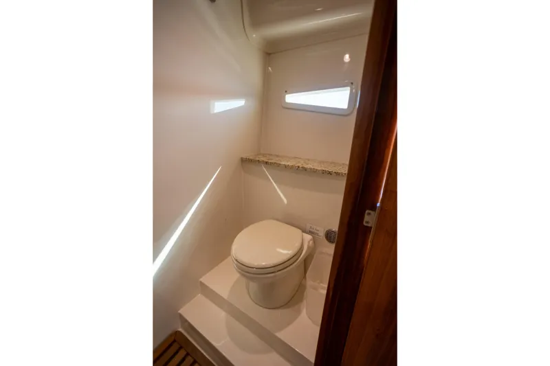  Yacht Photos Pics 2018 Cobalt 46 Yacht bathroom with modern toilet and small window.