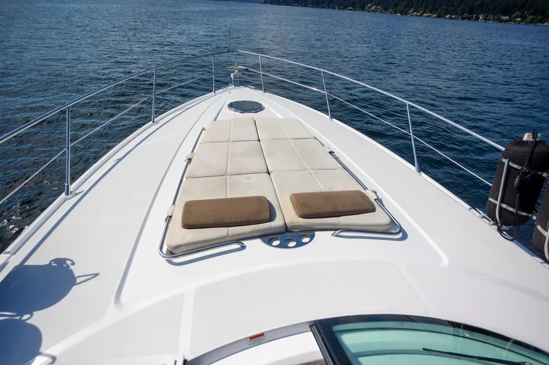  Yacht Photos Pics 2018 Cobalt 46 Yacht deck with sun loungers on calm water.