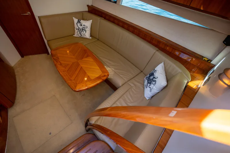  Yacht Photos Pics Luxurious interior of 2018 Cobalt 46 Yacht with elegant seating and wooden table.