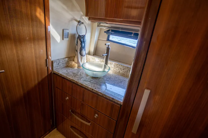  Yacht Photos Pics Luxurious bathroom interior of 2018 Cobalt 46 Yacht with modern sink and wooden cabinetry.