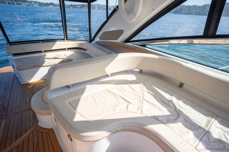  Yacht Photos Pics Luxurious interior of 2018 Cobalt 46 Yacht with cream seating and panoramic windows.