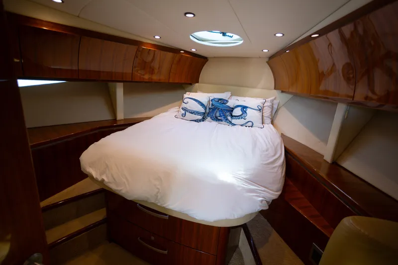  Yacht Photos Pics Luxurious 2018 Cobalt 46 Yacht cabin with elegant wood finish and cozy bedding.
