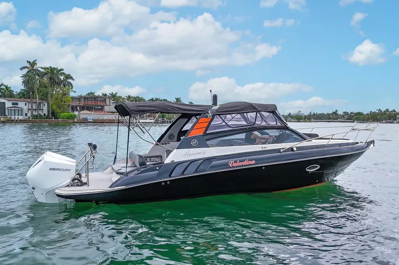  Yacht Photos Pics 2024 Hanover 305 boat on water, featuring sleek design and Mercury engine.