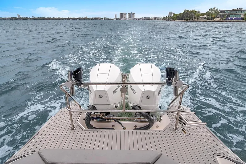  Yacht Photos Pics 2024 Hanover 305 boat with dual Mercury outboard engines on open water.