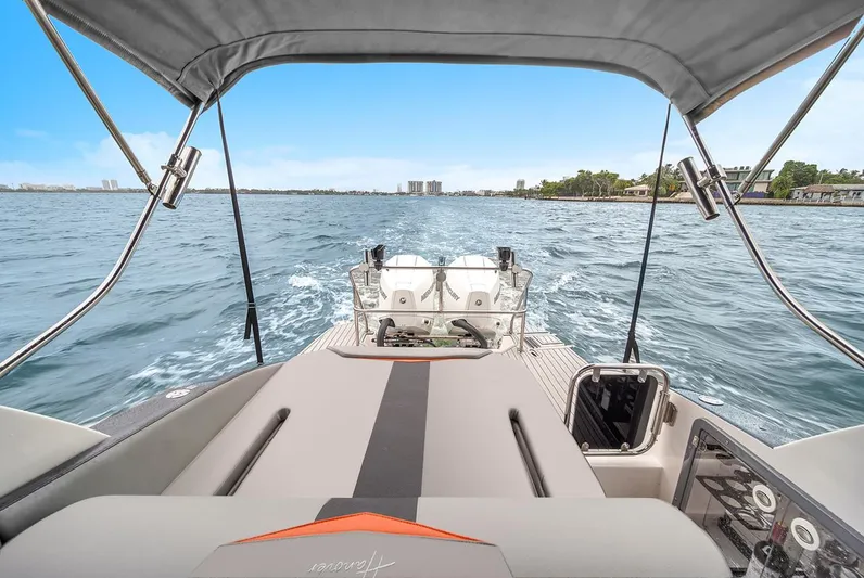  Yacht Photos Pics 2024 Hanover 305 boat cruising on open water, showcasing sleek design and spacious deck.