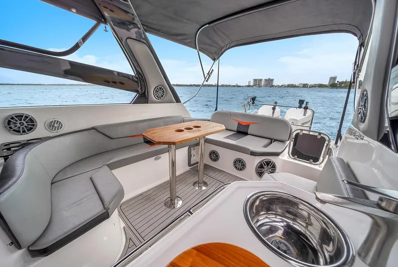  Yacht Photos Pics Luxurious 2024 Hanover 305 boat interior with seating and table on open water.