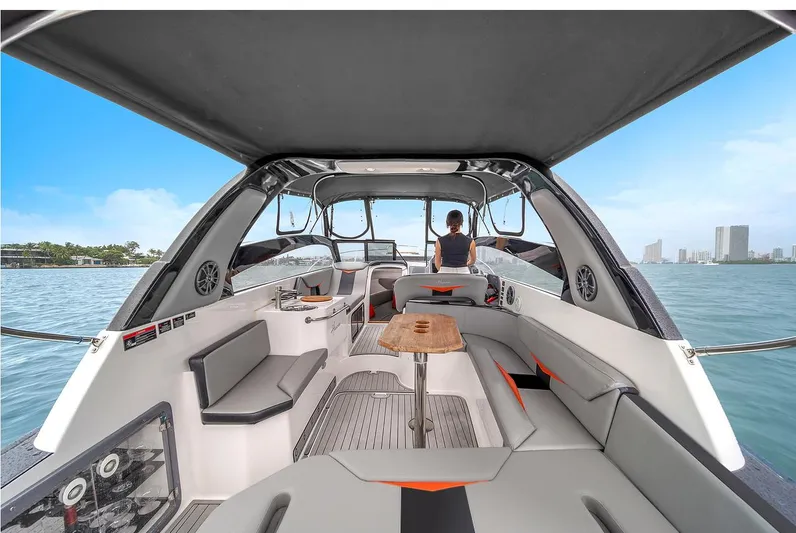  Yacht Photos Pics 2024 Hanover 305 boat interior with seating, table, and water view.