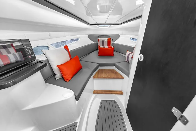  Yacht Photos Pics Luxurious interior of 2024 Hanover 305 boat with modern seating and vibrant cushions.