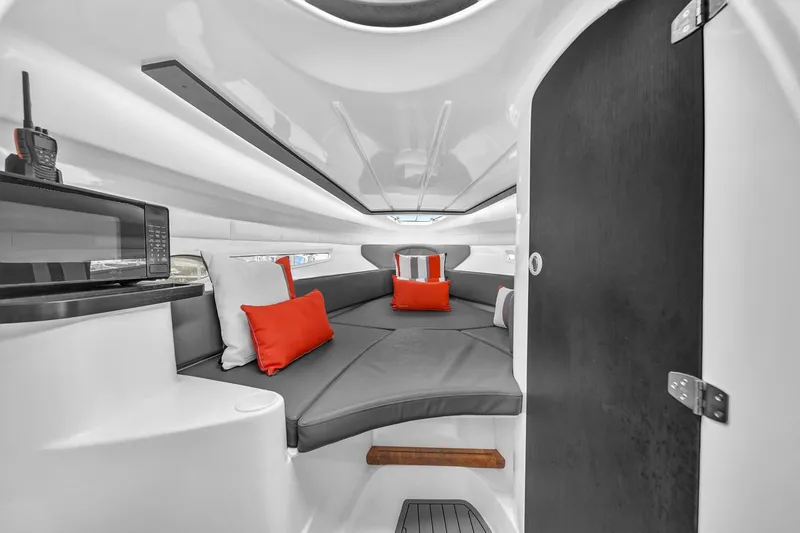  Yacht Photos Pics Luxurious interior of 2024 Hanover 305 boat with modern seating and vibrant cushions.