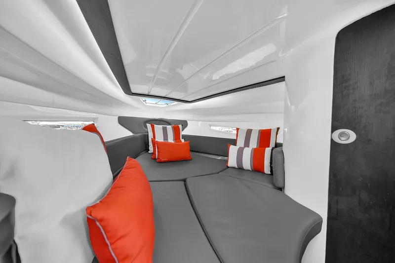  Yacht Photos Pics Luxurious interior of 2024 Hanover 305 boat with modern seating and vibrant cushions.