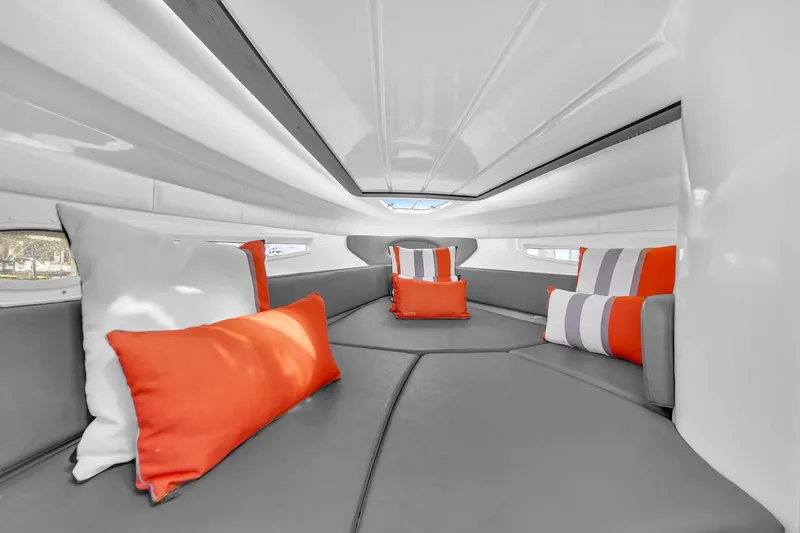  Yacht Photos Pics Luxurious interior of 2024 Hanover 305 boat with vibrant orange and white cushions.