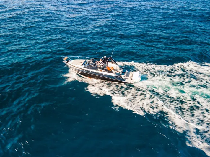  Yacht Photos Pics Aerial view of 2024 Hanover 305 boat cruising on open blue sea.