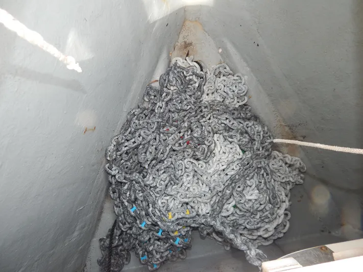  Yacht Photos Pics Anchor chain stored in the bow of a 1999 Oyster 42 Aft Cockpit Deck Saloon yacht.