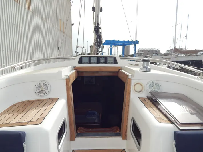  Yacht Photos Pics 1999 Oyster 42 Aft Cockpit Deck Saloon yacht interior with wooden accents and navigation instruments.