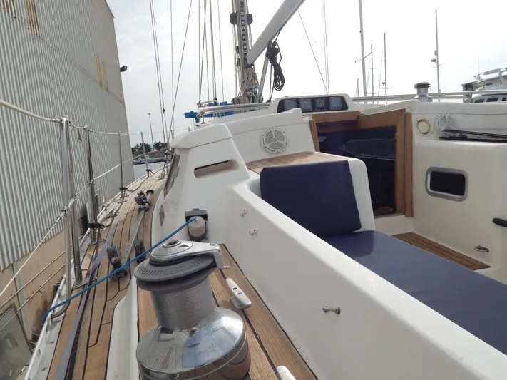  Yacht Photos Pics 1999 Oyster 42 Aft Cockpit Deck Saloon yacht with teak deck and blue seating.
