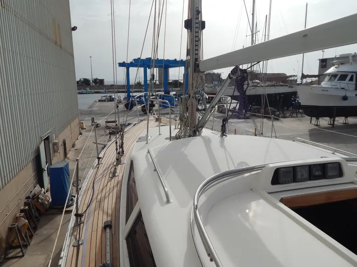  Yacht Photos Pics Sailboat deck view of 1999 Oyster 42 Aft Cockpit Deck Saloon in a marina.