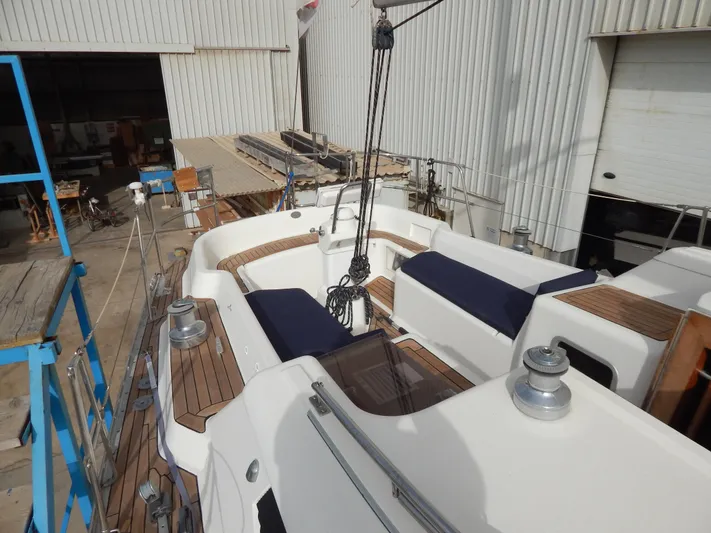  Yacht Photos Pics Aft cockpit of 1999 Oyster 42 yacht with teak decking and blue cushions.