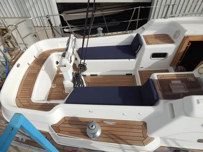  Yacht Photos Pics 1999 Oyster 42 Aft Cockpit Deck Saloon with teak deck and blue cushions.