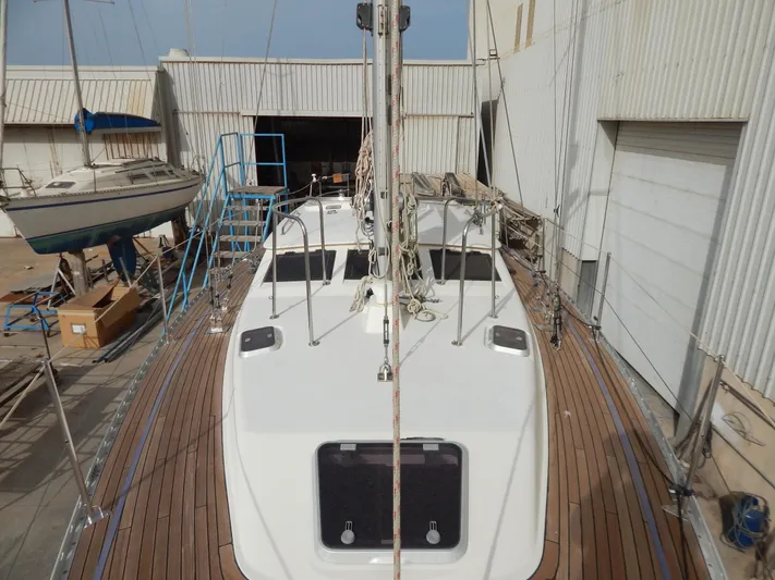  Yacht Photos Pics 1999 Oyster 42 Aft Cockpit Deck Saloon yacht in a shipyard setting.