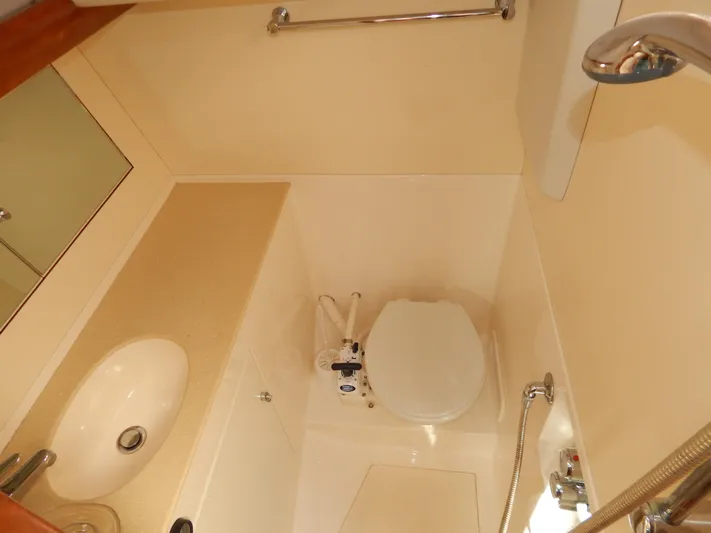  Yacht Photos Pics Compact bathroom in 1999 Oyster 42 Aft Cockpit Deck Saloon yacht.