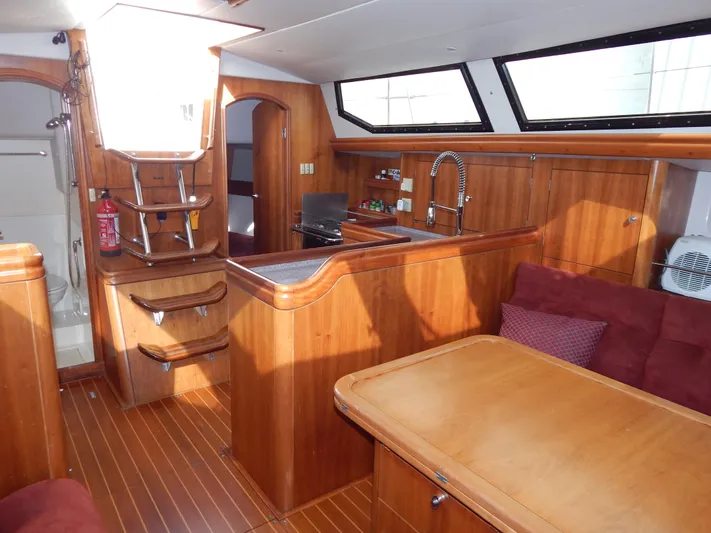  Yacht Photos Pics Interior of 1999 Oyster 42 yacht with wood finish and modern amenities.