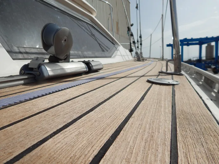  Yacht Photos Pics Teak deck of 1999 Oyster 42 Aft Cockpit Deck Saloon yacht, featuring sleek design elements.