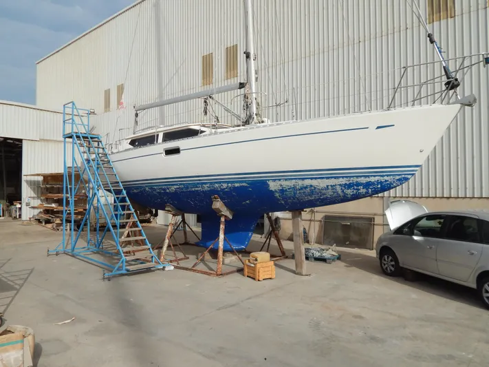  Yacht Photos Pics 1999 Oyster 42 Aft Cockpit Deck Saloon yacht in dry dock with blue hull.