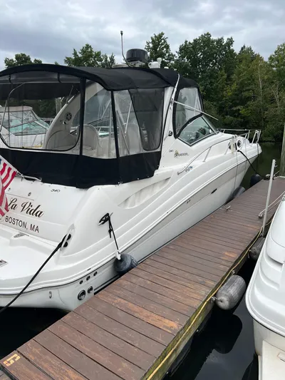 Viva La Vida Yacht Photos Pics 2006 Sea Ray 340 Sundancer docked, featuring sleek design and black canopy.