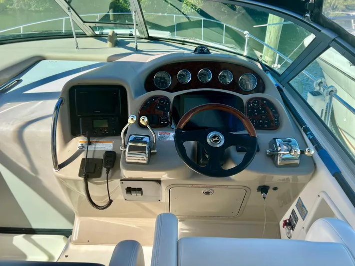 Viva La Vida Yacht Photos Pics 2006 Sea Ray 340 Sundancer helm with steering wheel, gauges, and controls.