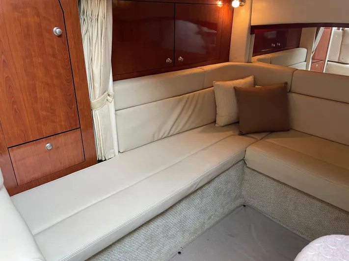 Viva La Vida Yacht Photos Pics Interior of 2006 Sea Ray 340 Sundancer with beige seating and wooden cabinetry.