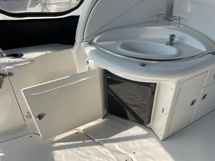 Viva La Vida Yacht Photos Pics 2006 Sea Ray 340 Sundancer interior with sink and open storage cabinet.