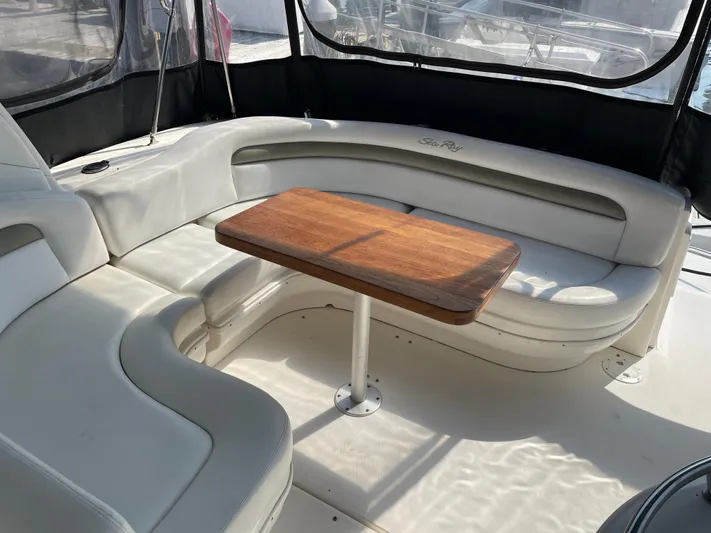 Viva La Vida Yacht Photos Pics Interior of 2006 Sea Ray 340 Sundancer with white seating and wooden table.