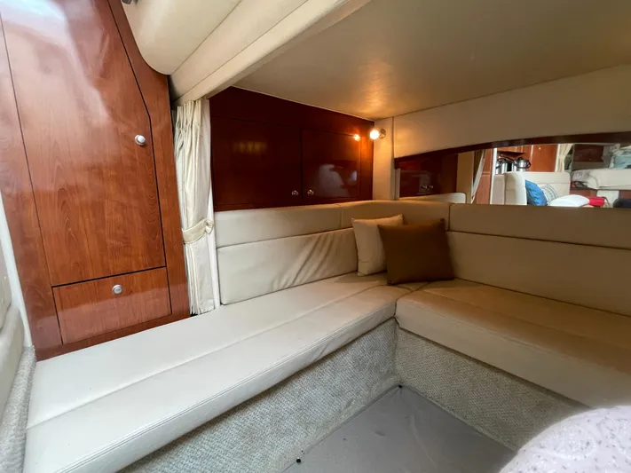 Viva La Vida Yacht Photos Pics Interior of 2006 Sea Ray 340 Sundancer with beige seating and wooden cabinetry.