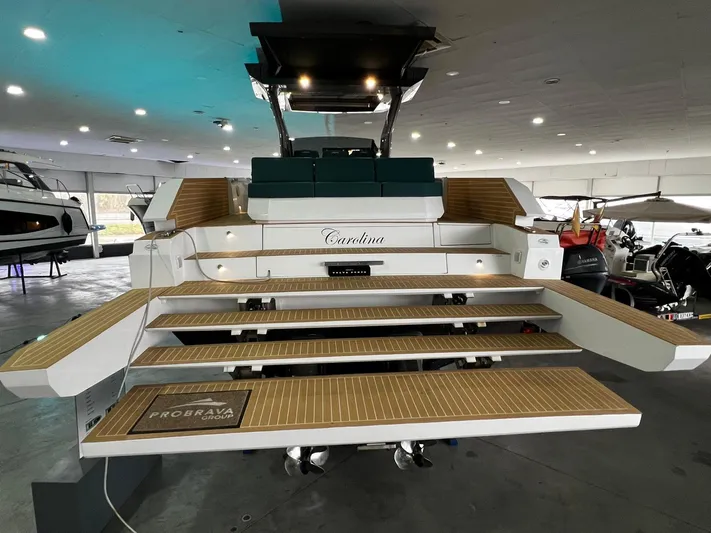 Fiart 39 Sw Yacht Photos Pics 2024 Fiart 39 Seawalker yacht with elegant wooden deck in a showroom setting.