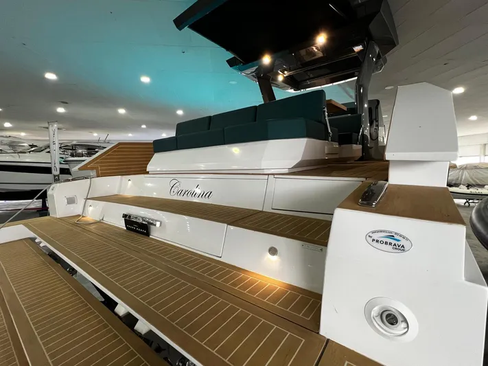 Fiart 39 Sw Yacht Photos Pics 2024 Fiart 39 Seawalker yacht with teak deck and modern seating in a showroom.