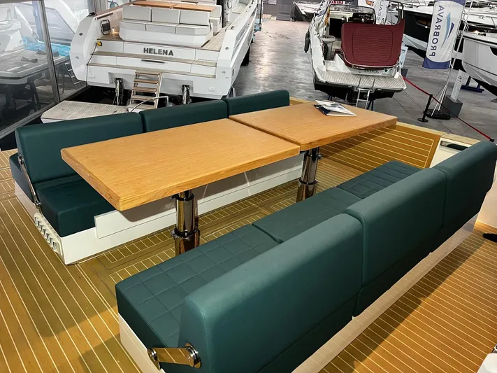 Fiart 39 Sw Yacht Photos Pics 2024 Fiart 39 Seawalker yacht interior with green seating and wooden table.