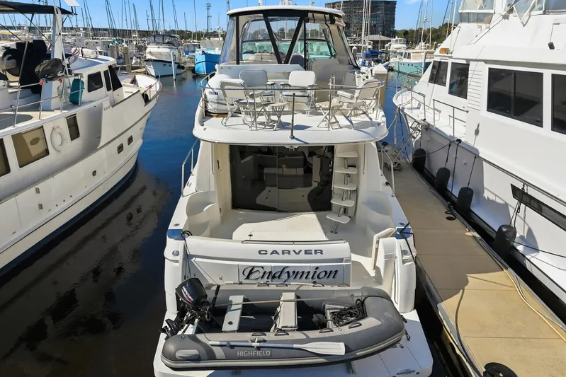 Endymion Yacht Photos Pics 2006 Carver 56 Voyager yacht docked at marina with inflatable boat.