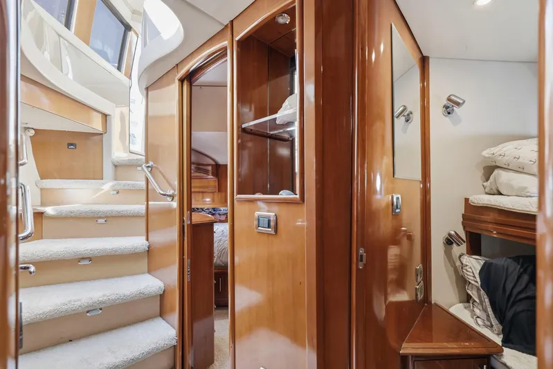 Endymion Yacht Photos Pics Interior of 2006 Carver 56 Voyager yacht with wooden finishes and cozy sleeping area.