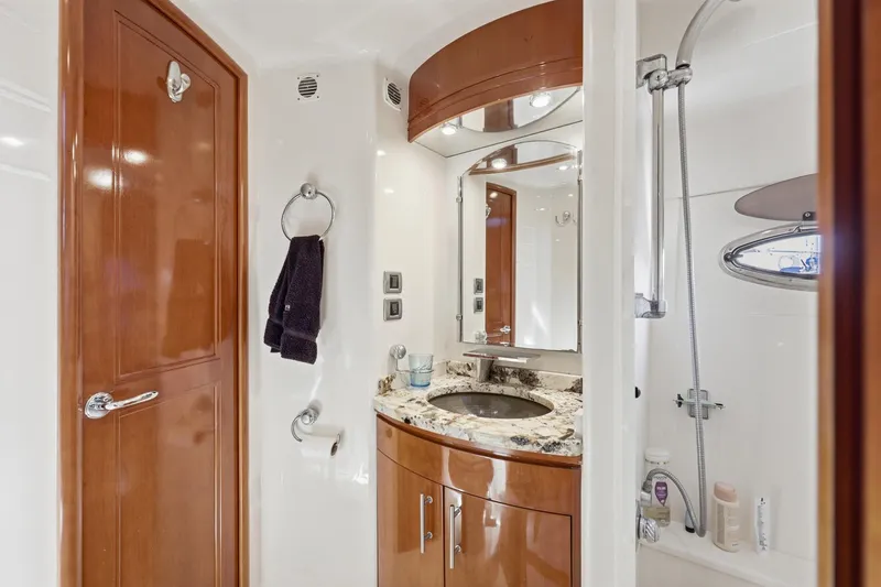 Endymion Yacht Photos Pics Luxurious bathroom in 2006 Carver 56 Voyager yacht with granite countertop and wooden cabinetry.