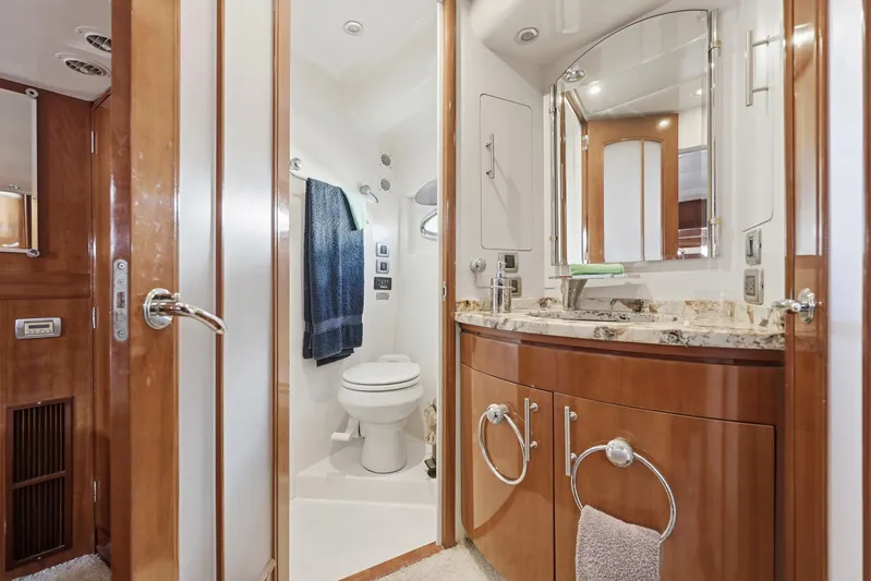 Endymion Yacht Photos Pics Luxurious bathroom in 2006 Carver 56 Voyager yacht with elegant wood cabinetry and modern fixtures.