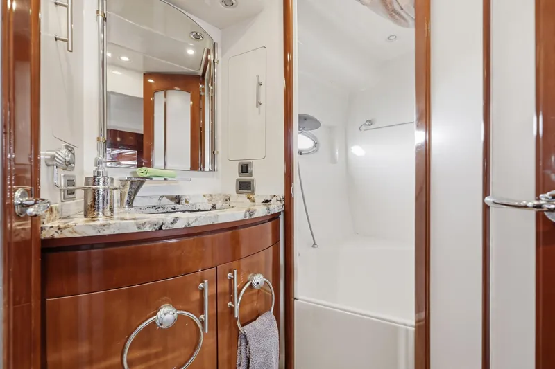 Endymion Yacht Photos Pics Luxurious bathroom interior of 2006 Carver 56 Voyager yacht with elegant wood finishes.