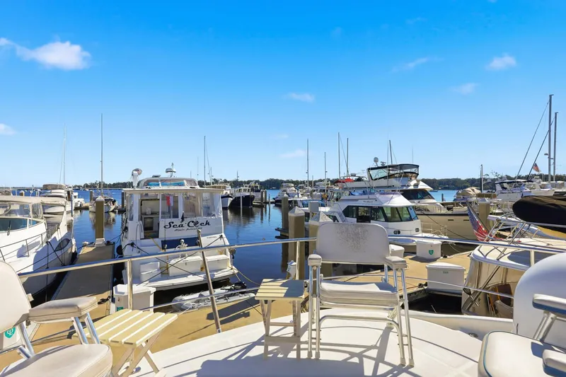 Endymion Yacht Photos Pics Marina view with 2006 Carver 56 Voyager yacht among docked boats under clear blue sky.