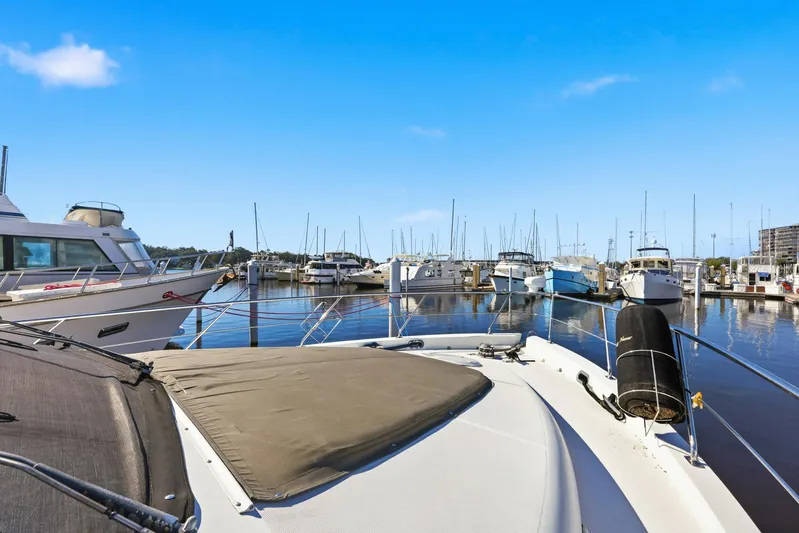 Endymion Yacht Photos Pics 2006 Carver 56 Voyager yacht docked at a marina under clear blue skies.