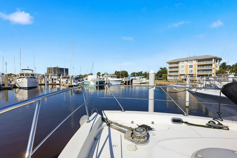 Endymion Yacht Photos Pics 2006 Carver 56 Voyager yacht docked at a marina with clear blue skies.