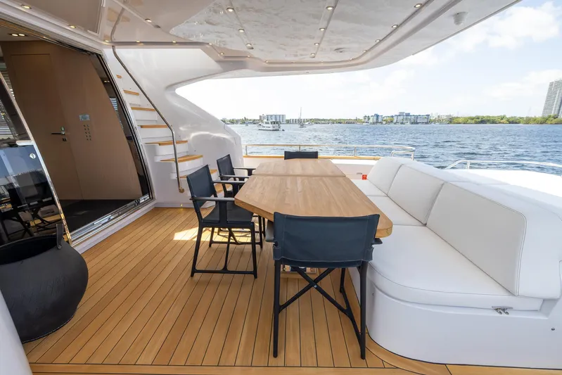 Sea Metri V Yacht Photos Pics Luxurious 2017 Amer 94 yacht deck with seating, wooden table, and scenic water view.