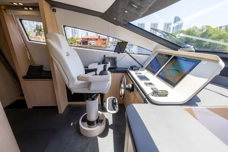 Sea Metri V Yacht Photos Pics Modern yacht cockpit with navigation screens, Amer 94 model, 2017, featuring a captain's chair.