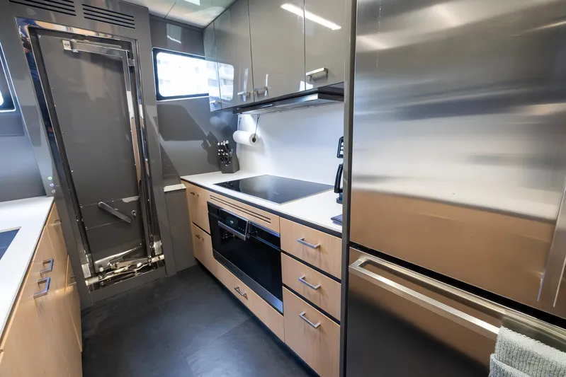 Sea Metri V Yacht Photos Pics Modern yacht kitchen with stainless steel appliances, sleek cabinetry, and compact design. Amer 94, 2017 model.