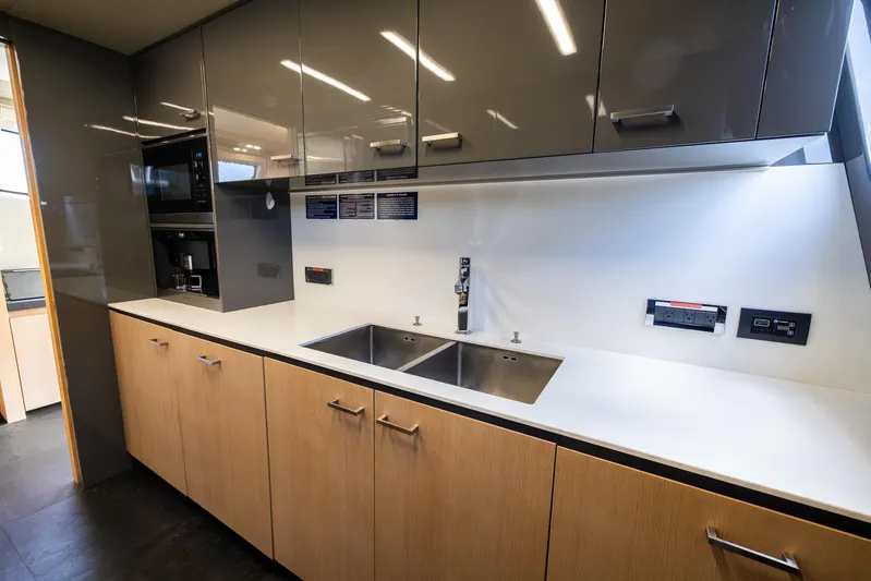 Sea Metri V Yacht Photos Pics Modern kitchen with dual sinks, sleek cabinetry, and integrated appliances on an Amer 94 yacht, 2017.